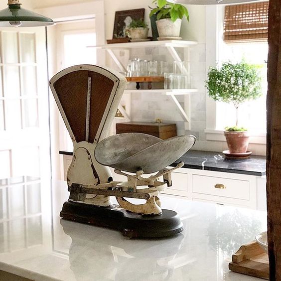 Eclectic Home Tour of The Cobbler Shop on Concord - love the antique scale on the kitchen counter kellyelko.com #farmhouse #farmhousedecor #interiordecor #interiordecorate #antiques #cottagestyle #hometour #housetour 