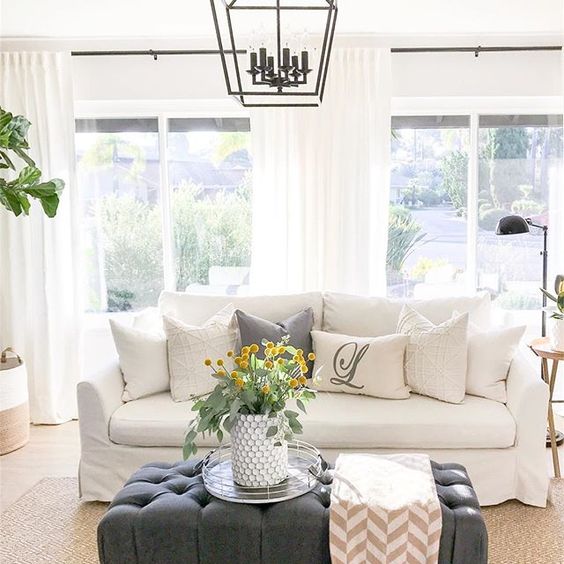 Eclectic Home Tour 1111 Light Lane - love the white slipcovered sofa and gray ottoman in this cottage kellyelko.com #slipcoveredsofa #neutraldecor #familyroom #familyroomdecor #ottoman #lighting #lanterns