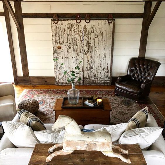 Eclectic Home Tour of The Cobbler Shop on Concord - love the DIY rolling barn doors to hide a tv kellyelko.com #farmhouse #farmhousedecor #interiordecor #interiordecorate #cottagestyle #hometour #housetour #diyideas #barndoors 