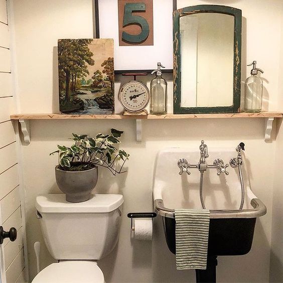 Eclectic Home Tour of The Cobbler Shop on Concord - love the sink that looks like an antique and the open shelf for display kellyelko.com #farmhouse #farmhousedecor #interiordecor #interiordecorate #bathroom #bathroomdecor #antique #powderroom #cottagestyle #hometour #housetour 