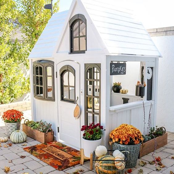 Eclectic Home Tour 1111 Light Lane - love this cute black and white playhouse on the patio kellyelko.com #fall #falldecor #playhouse #cottagestyle #farmhousestyle 