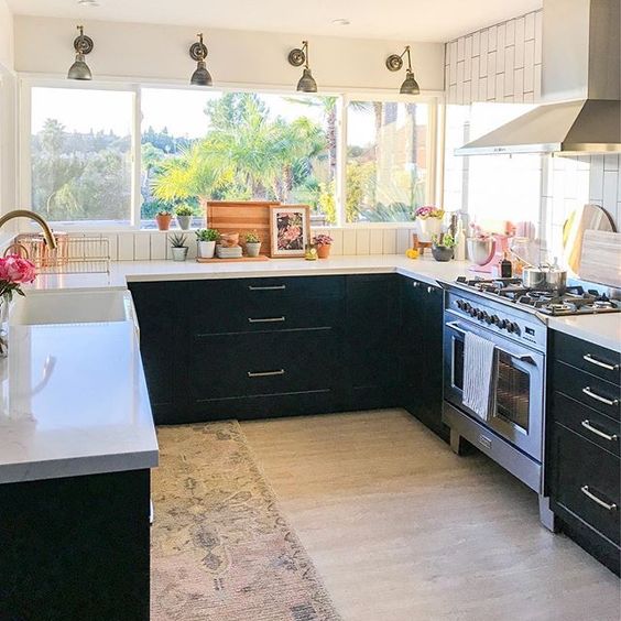 Eclectic Home Tour 1111 Light Lane - love this stunning kitchen with black cabinets and wrap around windows kellyelko.com #kitchen #kitchendecor #kitchendesign #kitchenrenovation #blackcabinets #farmhousestyle #cottagestyle