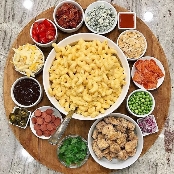 Love this idea for a mac and cheese board with all the mix ins kellyelko.com #macandcheese #comfortfood #appetizers #partyfood #recipes 