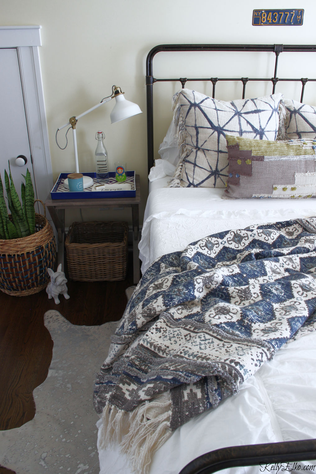 Guest Bedroom Decor - love the iron bed and white bedding with lots of fun pillows and throw kellyelko.com #bedroom #bedroomdecor #bedroomfurniture #bedroomdecorating #guestbedroom #bohodecor #boho