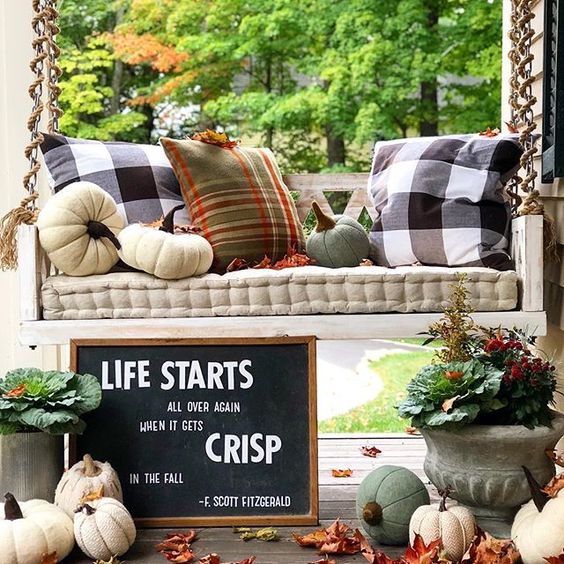 Eclectic Home Tour of The Cobbler Shop on Concord - love this fun fall porch with hanging swing kellyelko.com #farmhouse #farmhousedecor #interiordecor #interiordecorate #fall #falldecor #cottagestyle #hometour #housetour #porch #porchdecor