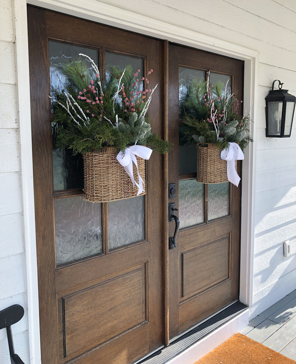 Beautiful baskets filled with greenery and berries replace traditional Christmas wreaths 