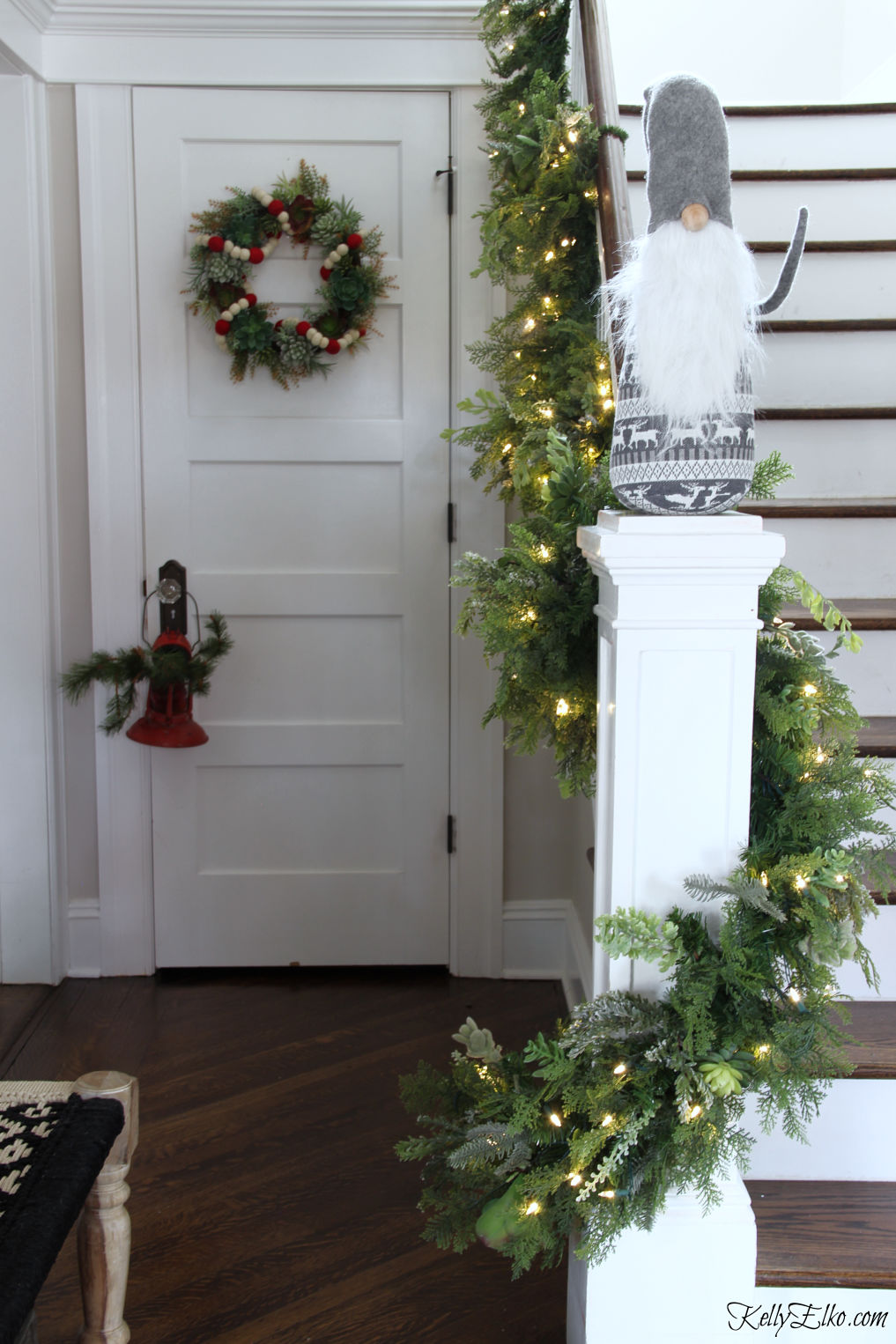 Love her creative Christmas home and the succulent garland on the bannister kellyelko.com #christmas #christmasdecor #christmasfoyer #diychristmas #gnomes #diywreath #christmashome 