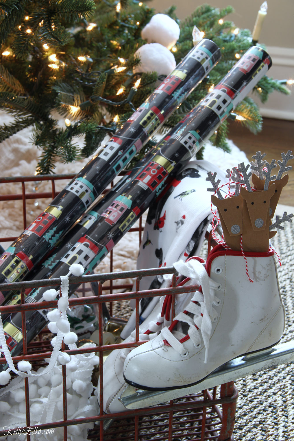 Love this cute little gift wrap station in an old crate with a pair of skates to hold gift tags kellyelko.com #christmasdecor #christmaswrap #christmaswrapping #giftwrap #christmasdecorating #vintagechristmas #diychristmas 