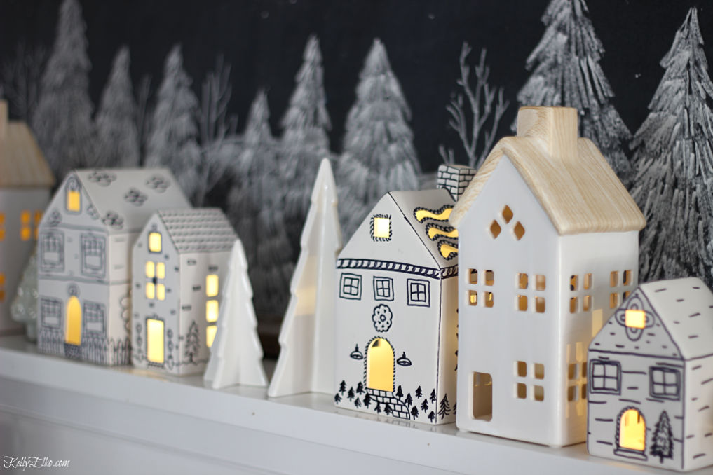 Love these little doodled ceramic houses on this Christmas mantel kellyelko.com #christmasdecor #diychristmas #christmascrafts #sharpiecrafts #christmasmantel #farmhousechristmas 