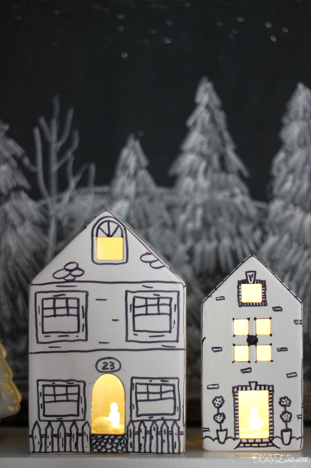 Love these little doodled ceramic houses on this Christmas mantel kellyelko.com #christmasdecor #diychristmas #christmascrafts #sharpiecrafts #christmasmantel #farmhousechristmas 