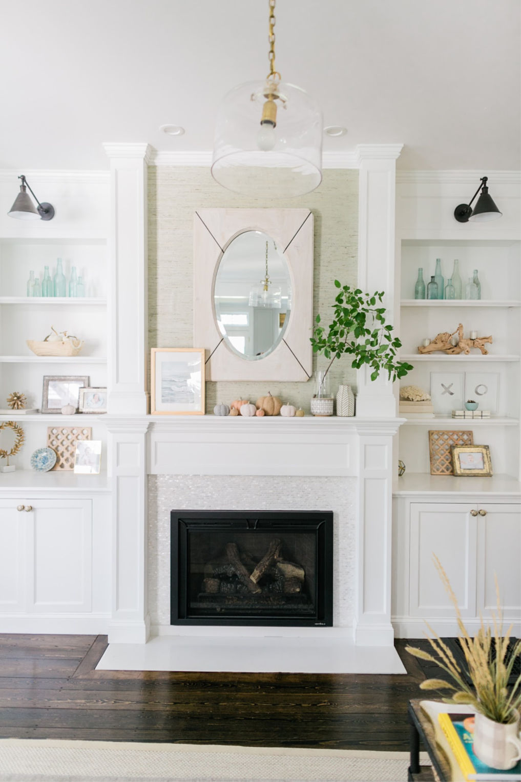 Love this fireplace with white stone tile surround and built in bookshelves kellyelko.com #mantel #manteldecor #fireplace #farmhousestyle 