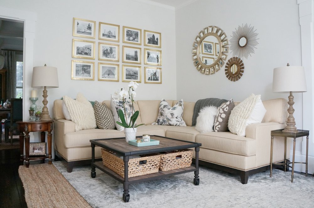 Sectional sofa in a cozy family room and I love the gallery wall of travel photos kellyelko.com #gallerywall #sectionalsofa #familyroom #familyroomdecor #neutraldecor #interiordecor