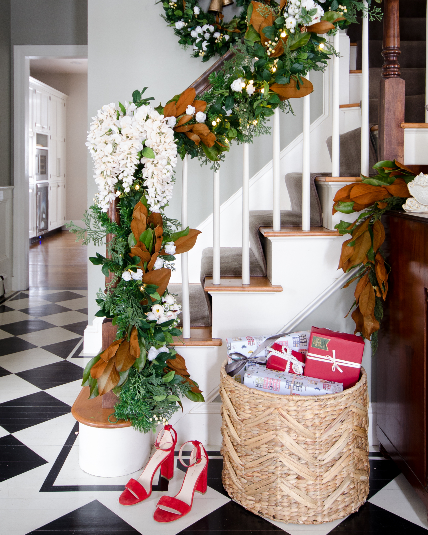 Beautiful banister garland with magnolia leaves and white flowers 