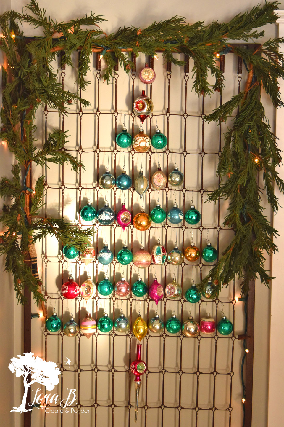 Shiny Brite Decorating Ideas - the most creative ideas for displaying Christmas ornaments like this ornament tree hung on an old bedspring kellyelko.com #vintagechristmas #christmasornaments #christmaswreath #christmasdecor #christmasdecorating #shinybrites #vintageornaments #ornaments #christmastree 