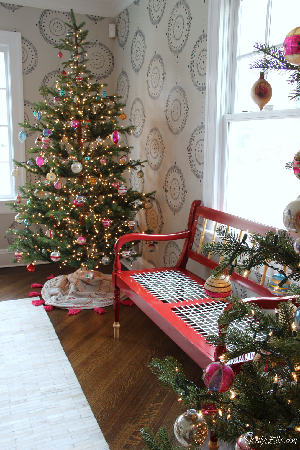 Love these sparse Christmas trees filled with vintage Shiny Brite ornaments and how cool is the tassel tree skirt kellyelko.com #christmastree #christmasdecor #christmasdecorations #christmaslights #diychristmas #treeskirt 