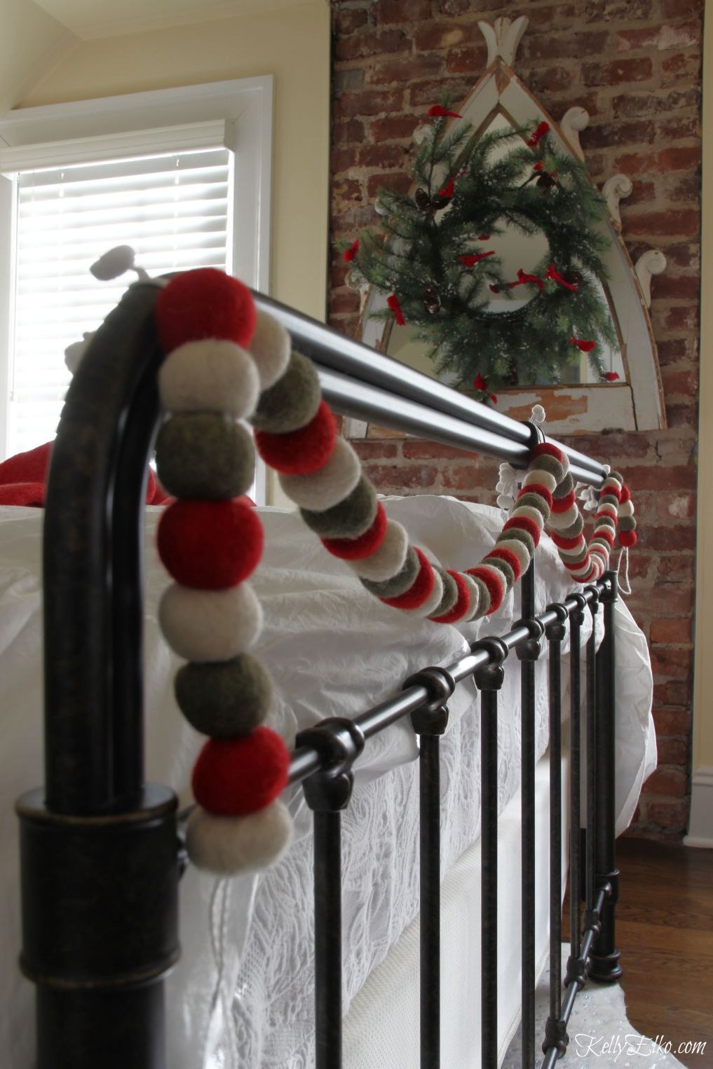 Cozy Christmas Guest Bedroom - love the flannel sheets, fringe throw and other whimsical decorating ideas kellyelko.com #christmas #christmasbedroom #christmasdecor #christmasdecorating #christmasbedding #christmaswreath #vintagechristmas #garland #bedroomfurniture 