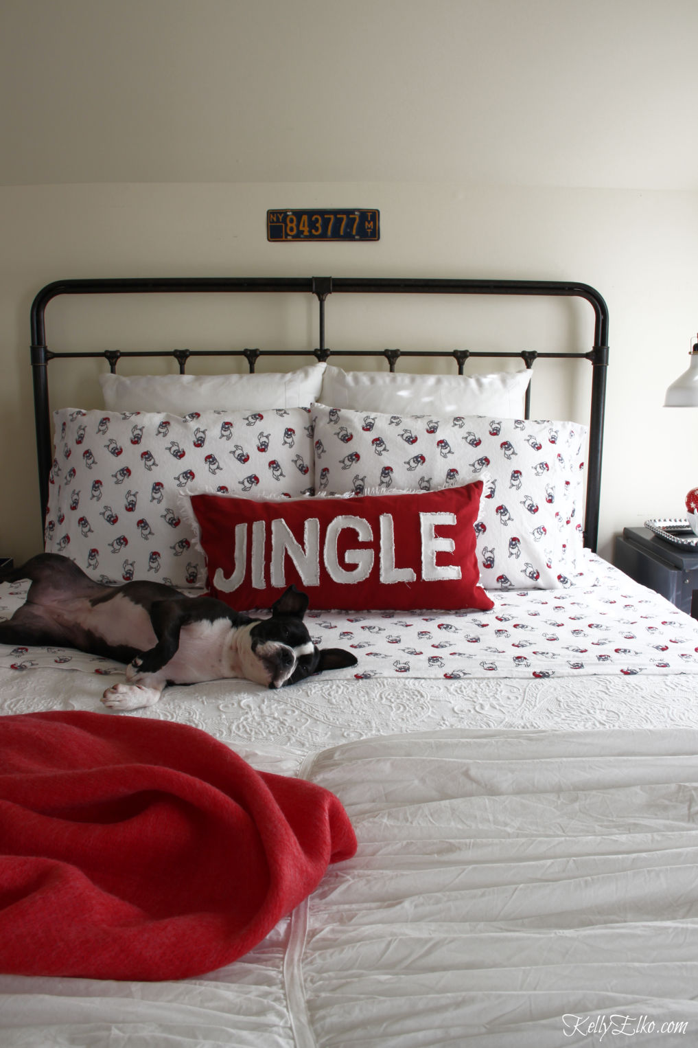 Cozy Christmas Guest Bedroom - love the flannel sheets, fringe throw and other whimsical decorating ideas kellyelko.com #christmas #christmasbedroom #christmasdecor #christmasdecorating #christmasbedding #christmaswreath #vintagechristmas #bostonterrier #frenchbulldog