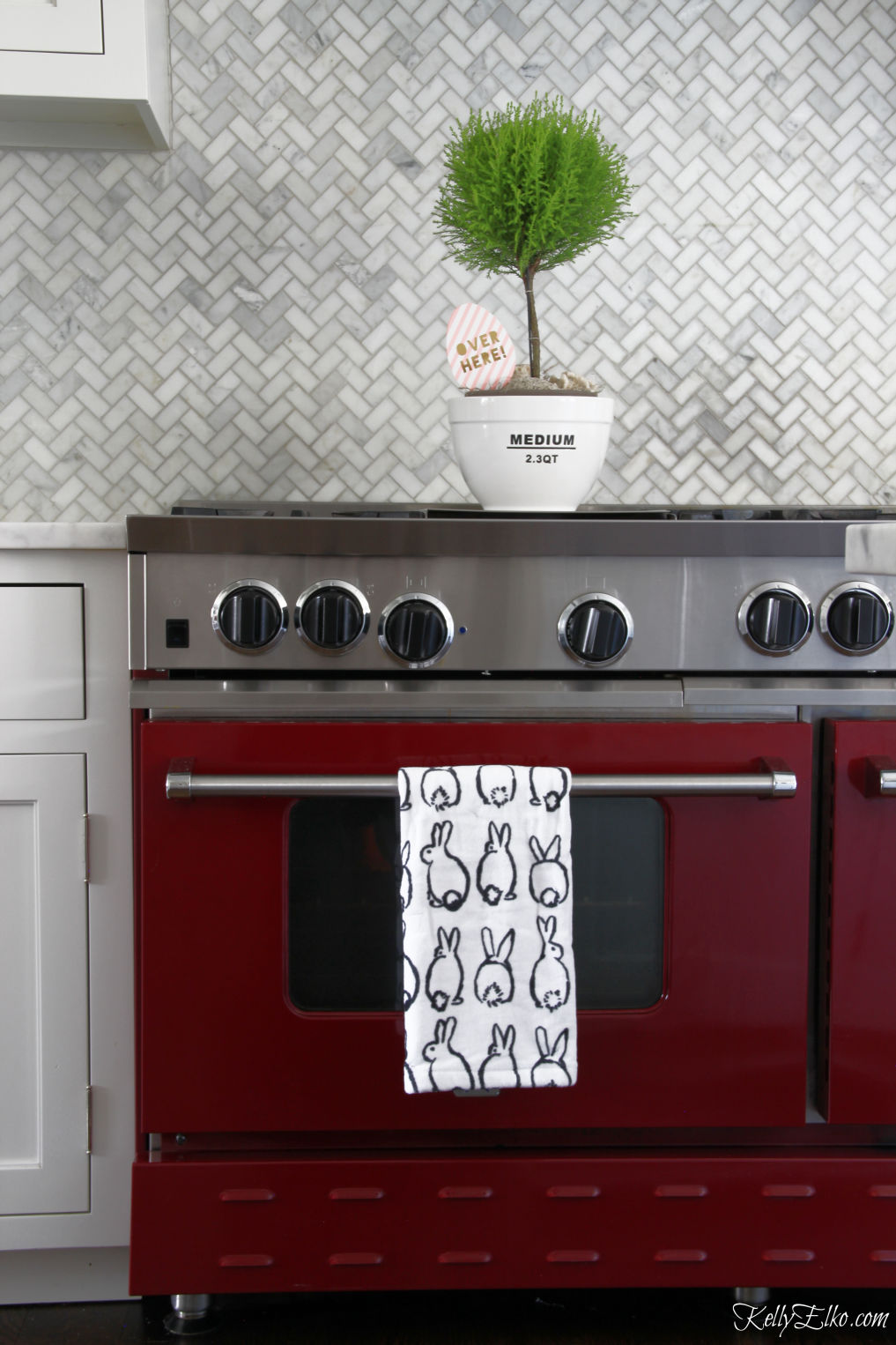 Love this red stove and the marble herringbone tile backsplash kellyelko.com #kitchen #stove #kitchenappliances #appliances #red #whitekitchen #kitchendecor 