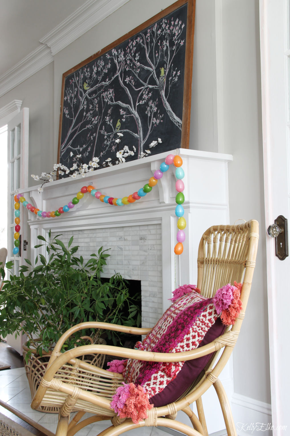 Spring chalkboard mantel - love the original chalk art on the vintage chalkboard and the DIY egg garland kellyelko.com #easter #easterdecor #spring #springdecor #mantel #springmantel #eastereggs #diycrafts #eastercrafts #springcrafts #lighting #plants 