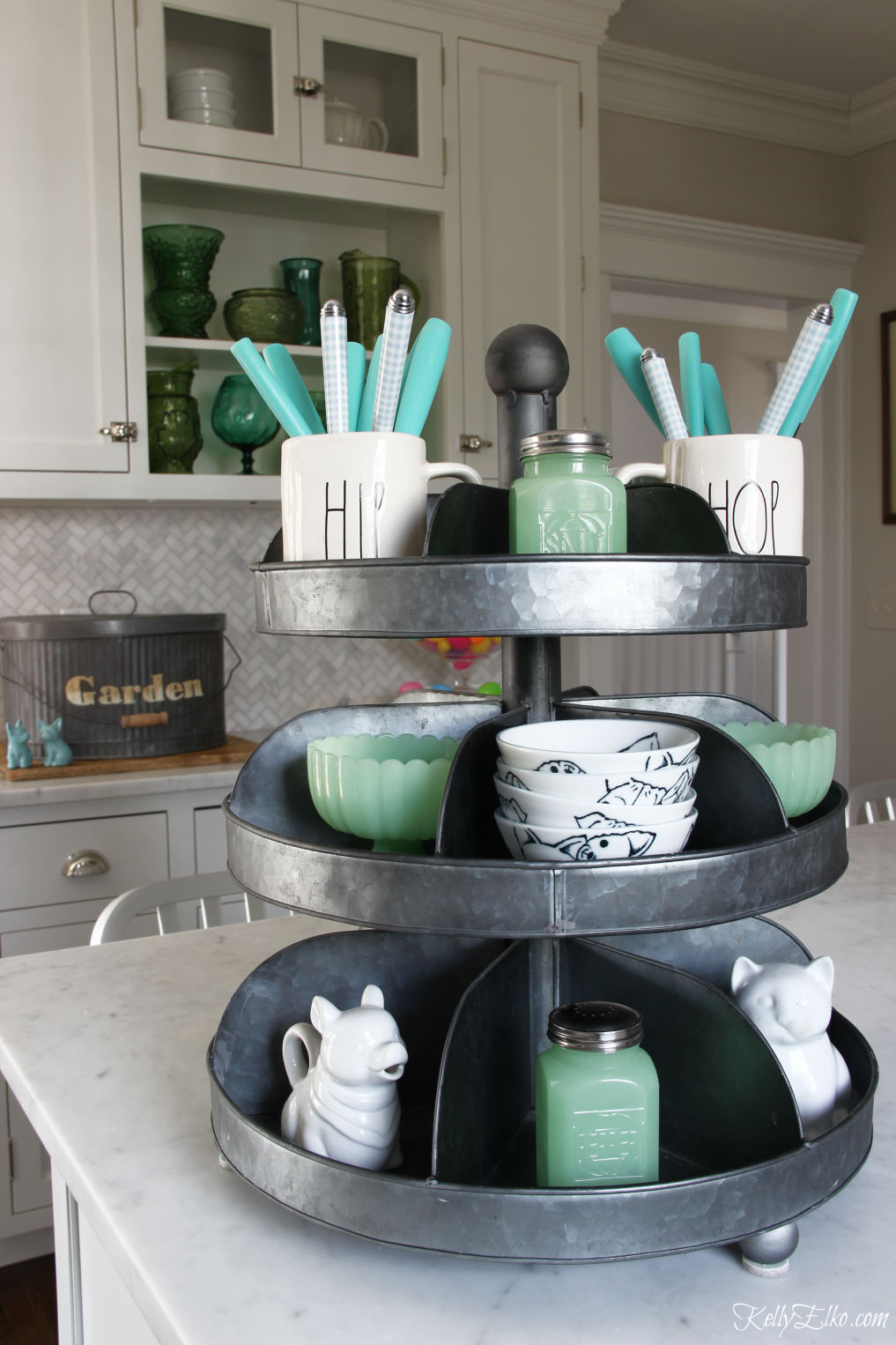 Love this tiered tray for storing everyday kitchen essentials kellyelko.com #farmhousekitchen #whitekitchen #industrialdecor #trays #tieredtray #farmhousedecor #fixerupperstyle #springdecor #jadeite #raedunn #kitchendecor #kellyelko