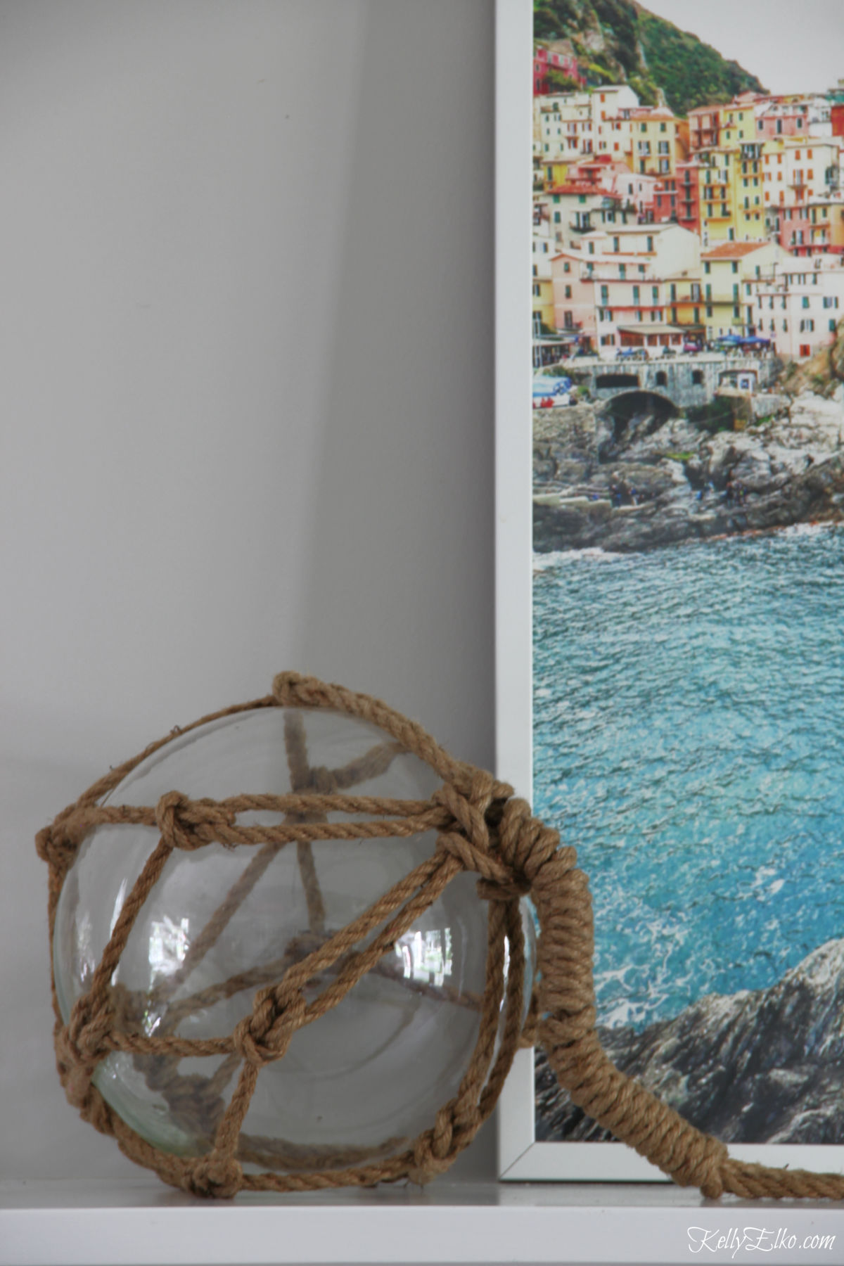 Love this jute wrapped buoy on this coastal summer mantel kellyelko.com #buoy #summer #coastal #coastaldecor 