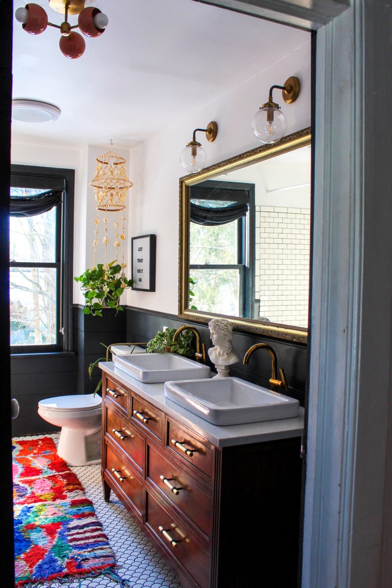 Love this bathroom remodel with repurposed dresser turned vanity and colorful boho accessories kellyelko.com #bathroom #bathroomdecor #bathroomremodel #bohodecor #vintagedecor #lighting #bathroomlighting