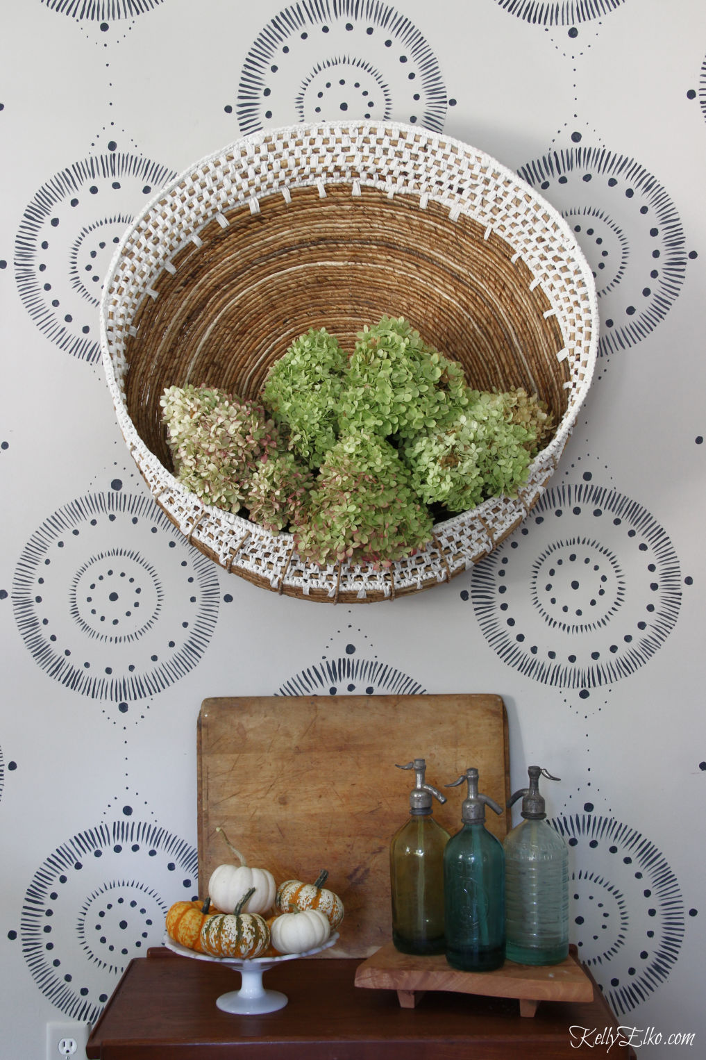 Bar Cart Styling - three different looks! Love the huge wall basket filled with hydrangeas for fall and the vintage finds kellyelko.com #barcart #bohodecor #eclecticdecor #homedecor #falldecor #falldecorating #pumpkins #vintagdecor 