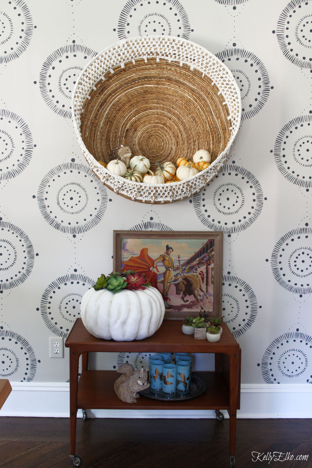 Love this boho wall basket and bar cart styled for fall kellyelko.com #fall #falldecor #pumpkins #pumpkindecor #vintagedecor #barcart #autumndecor #eclecticdecor #bohodecor