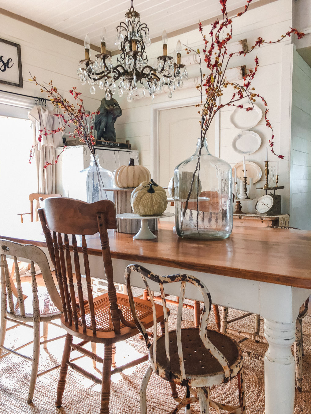 Farmhouse dining room with mismatched vintage chairs and pumpkin centerpiece kellyelko.com #falldecor #falldecorating #diningroom #farmhousediningroom #farmhousedecor #farmhousestyle #centerpiece #shiplap 