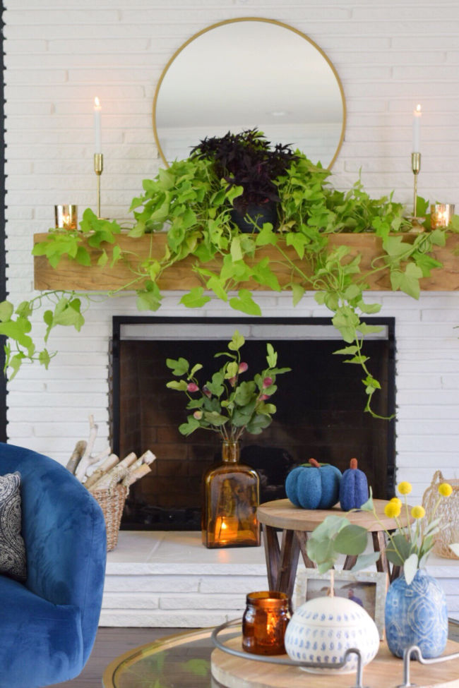 12 Creative Fall Mantels - love this trailing vine hanging from the mantel kellyelko.com #mantel #manteldecor #houseplants #plantlady #falldecor #fallmantel #eclecticstyle 