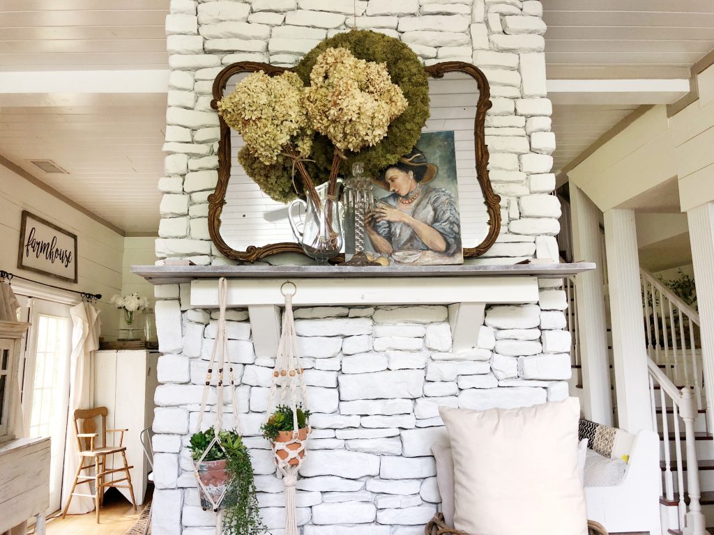 Love this stacked stone fireplace and vintage finds on the mantel kellyelko.com #fireplace #farmhousefireplace #stackedstone #rusticdecor #vintagedecor #farmhousedecor #farmhousestyle #neutraldecor 