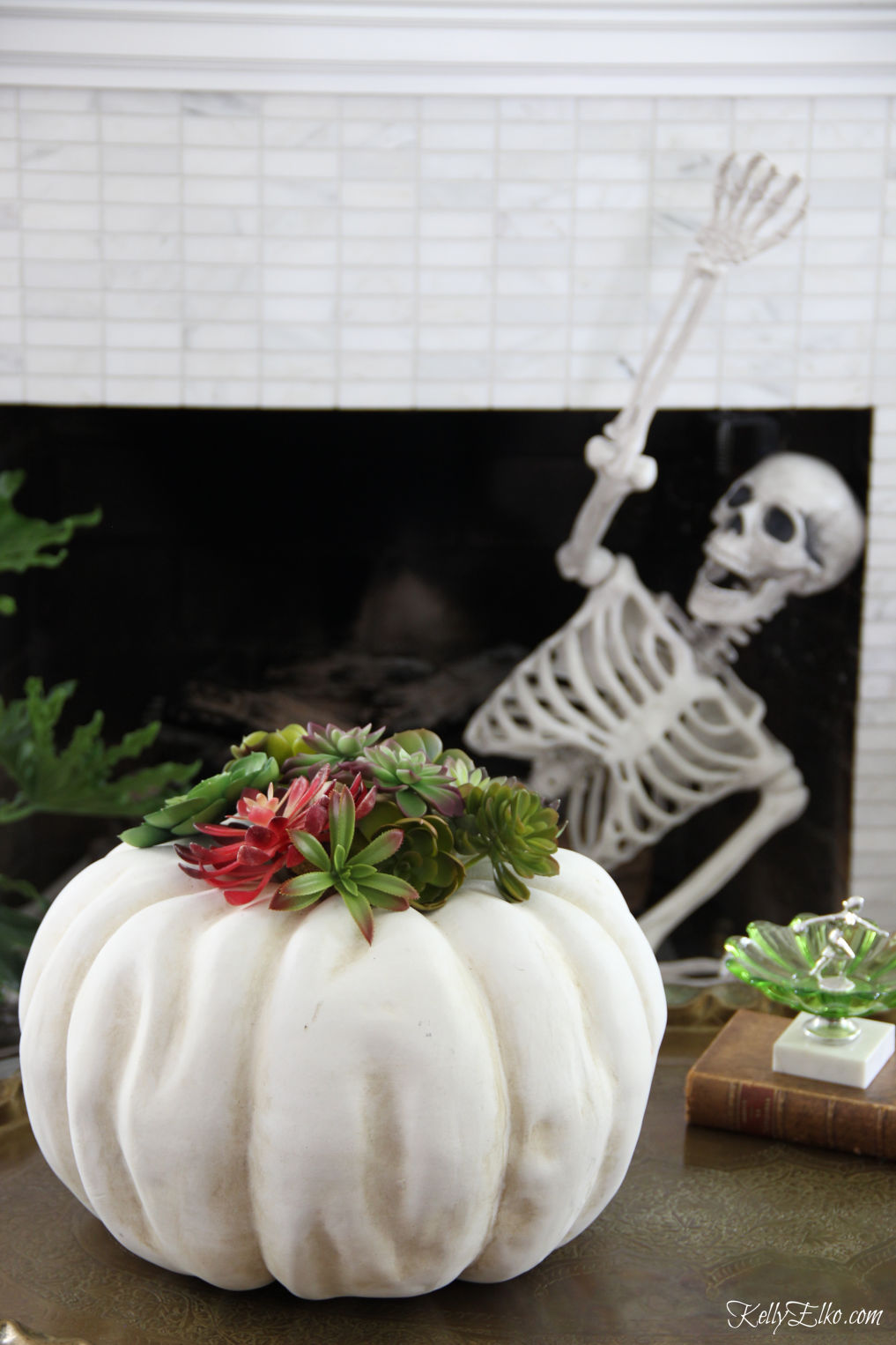 Love this Halloween home and the succulent pumpkin kellyelko.com #halloween #halloweendecor #halloweendecorations #skeleton #pumpkindecor #succulents 