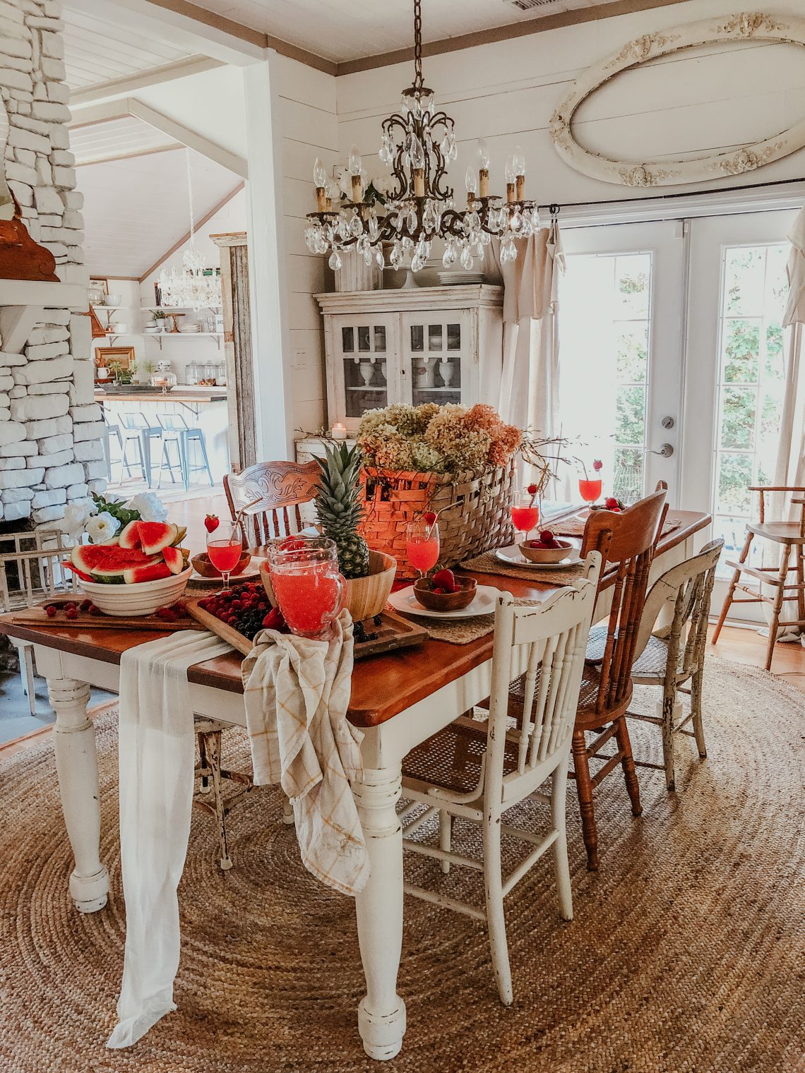 Beautiful farmhouse dining room with mismatched old chairs and crystal chandelier kellyelko.com #diningroom #diningroomdecor #vintagedecor #farmhousedecor #farmhousestyle #neutraldecor #shiplap 