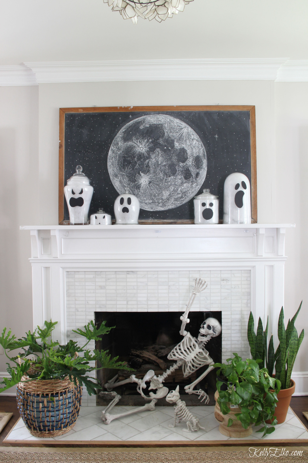 Love this Halloween mantel with the skeleton in the fireplace and she shows how to make glass jar ghosts! - kellyelko.com #halloween #halloweencrafts #halloweendecor #halloweendecorations #diyhalloween #diyhalloweendecorations #ghosts #skeleton #halloweenhouse #halloweenmantel #vintagehalloween
