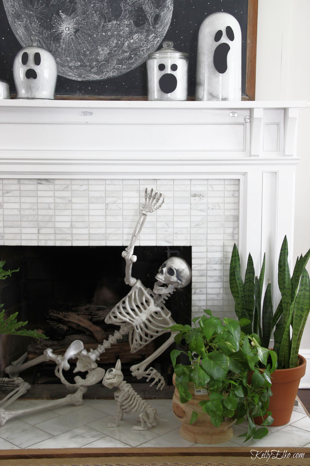 Love this Halloween mantel with the skeleton in the fireplace and she shows how to make glass jar ghosts! - kellyelko.com #halloween #halloweencrafts #halloweendecor #halloweendecorations #diyhalloween #diyhalloweendecorations #ghosts #skeleton #halloweenhouse #halloweenmantel #vintagehalloween