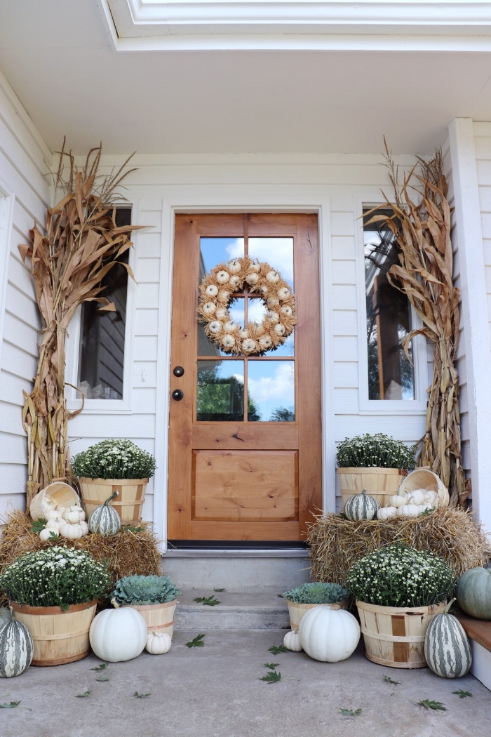 10 Beautiful Fall Porches - love the white mums and pumpkins for a neutral fall look kellyelko.com #fall #fallporch #falldecor #falldecorating #mums #pumpkins #fairylights #porch #frontporch #curbappeal #autummdecor #autummporch #neutralfall 