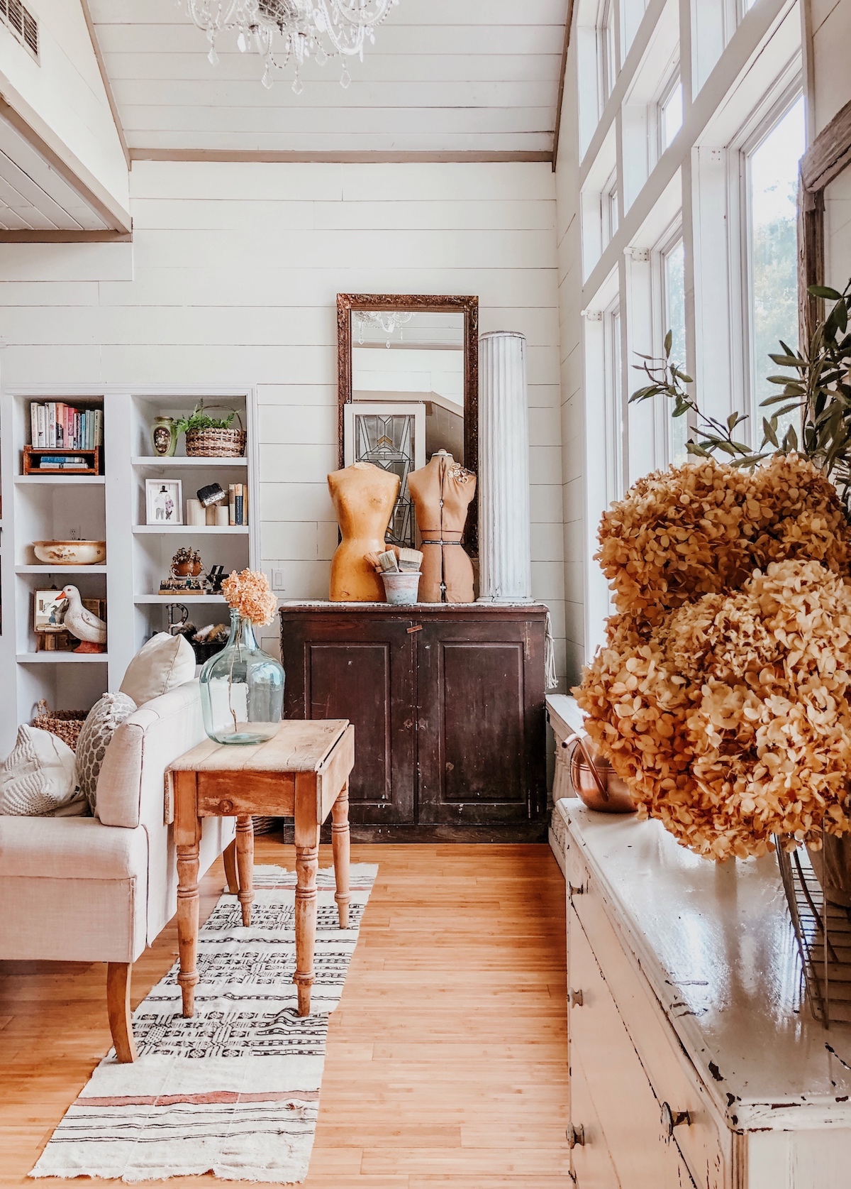 Farmhouse style with white shiplap walls and beautiful vintage displays including this pair of dress forms kellyelko.com #farmhouse #farmhousedecor #vintagedecor #eclecticdecor 