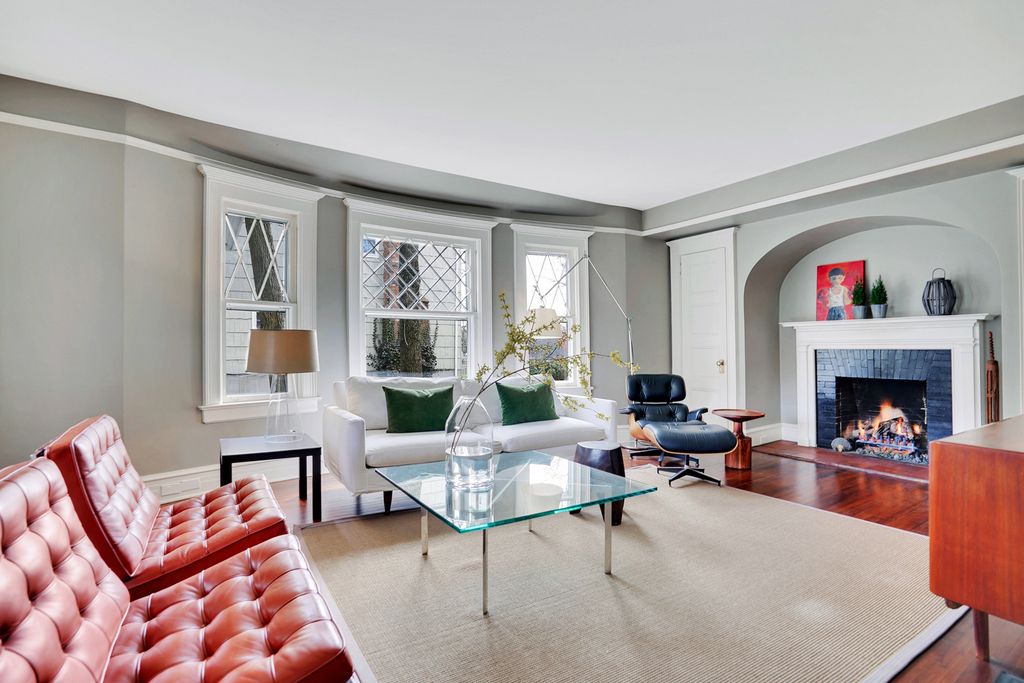 Love the original architectural details in this old home combined with modern furniture kellyelko.com #livingroomdecor #fireplace #manteldecor #oldhome #oldhouse #architecture #interiordesign #graypaint #neutraldecor 