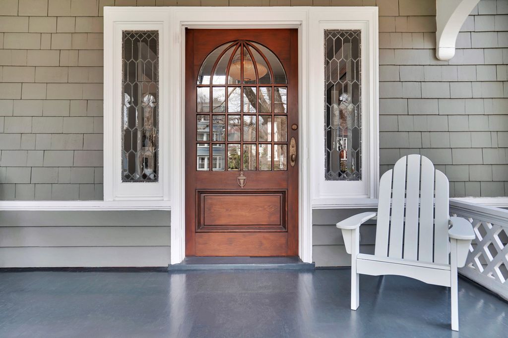 Eclectic Home Tour Carpenter Gothic - love the original front door and leaded glass sidelights in this 1900 home kellyelko.com #home #frontdoor #oldhome #oldhouse #hometour #housetour #architecture #victorian #olddoor #porch #frontporch