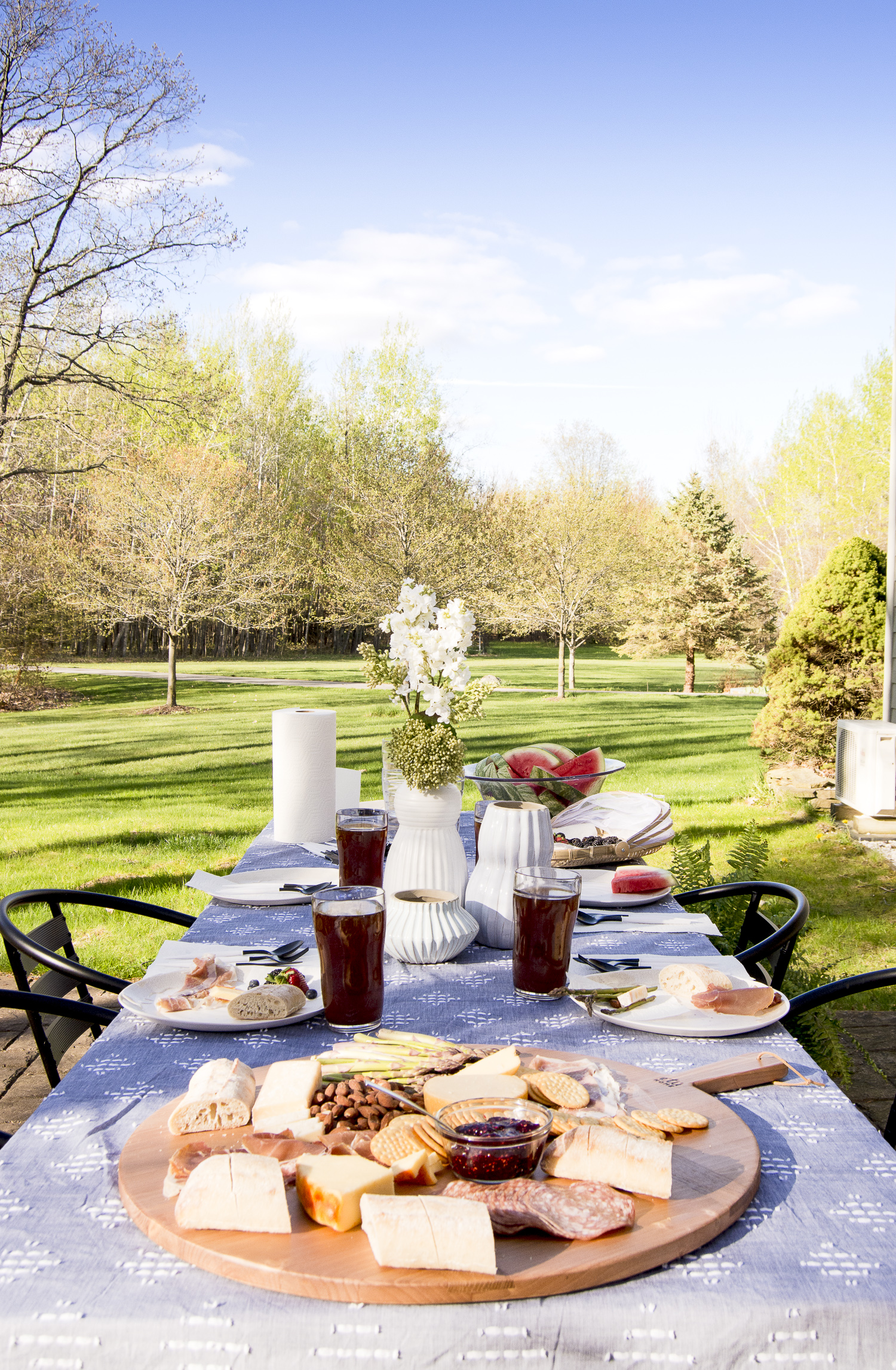 Beautiful table with charcuterie board kellyelko.com #charcuterie #outdoordining #outdoordecor #tablesetting #outdoors #backyarddecor