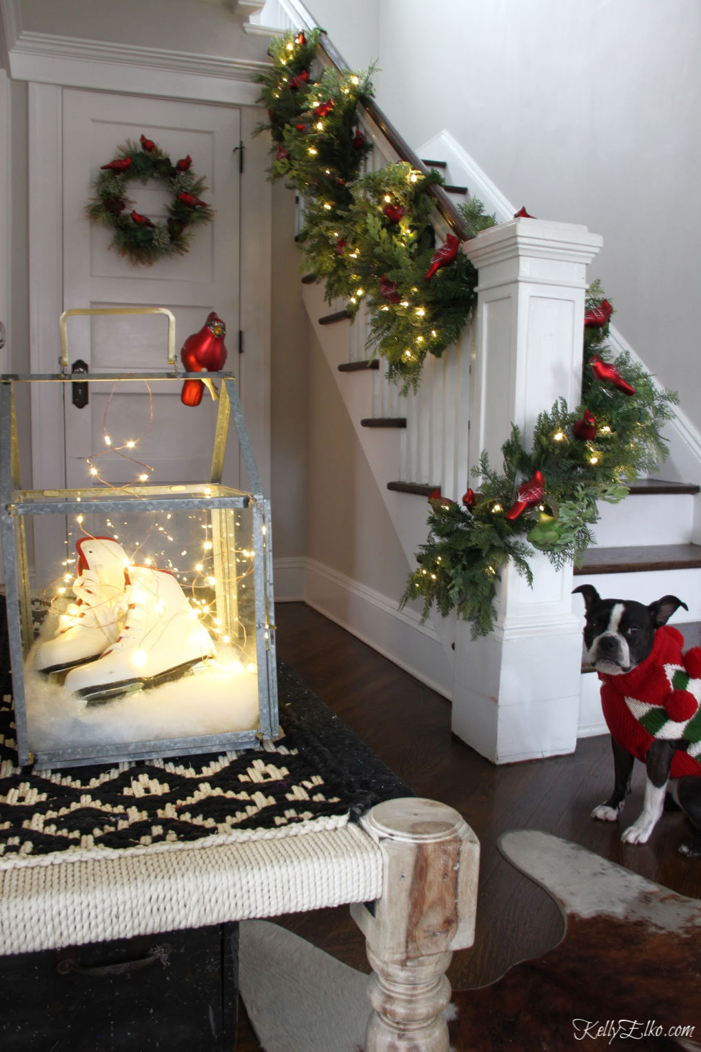 Creative Christmas Home Tour - love this bannister of succulent garland filled with a flock of cardinal ornamentskellyelko.com #christmas #christmasdecor #christmasdecorating #christmashome #christmastour #diychristmas #christmasideas #christmasmantel #christmastree #christmasornaments #vintagechristmas #farmhousechristmas #colorfulchristmas #creativechristmas #kellyelko #christmasbannister #christmasentry #christmasstairs #christmaslights #christmasdog