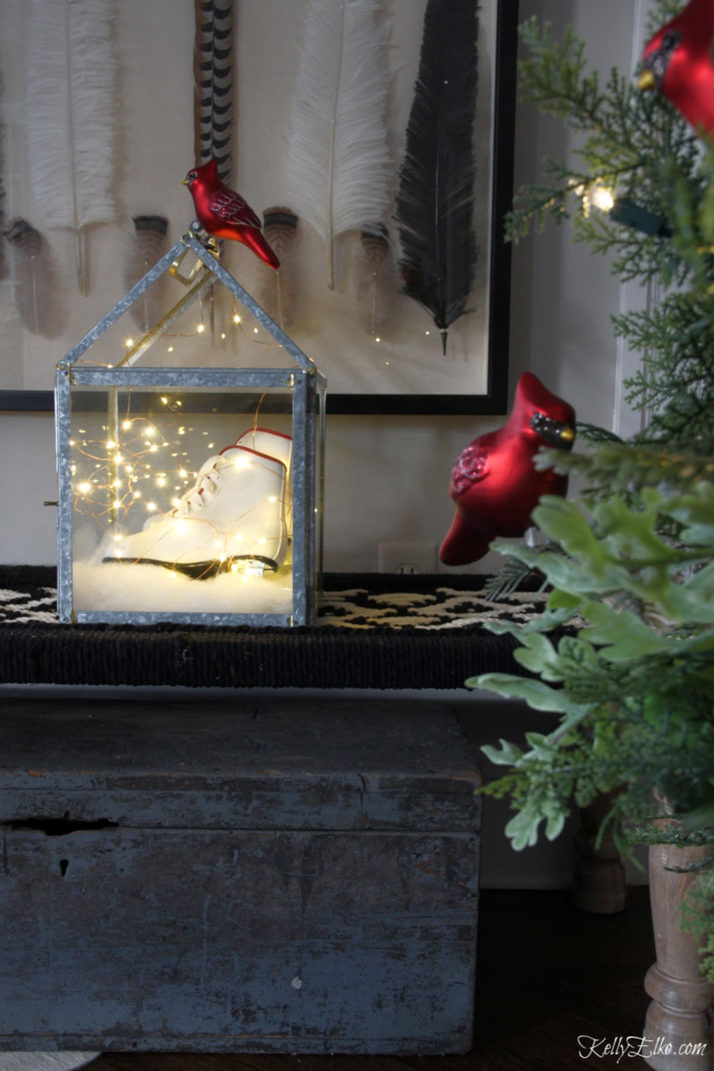 Creative Christmas Home Tour - love the lantern filled with ice skates and fairy lights kellyelko.com #christmas #christmasdecor #christmasdecorating #christmashome #christmastour #diychristmas #christmasideas #christmasmantel #christmastree #christmasornaments #vintagechristmas #farmhousechristmas #colorfulchristmas #creativechristmas #kellyelko #fairylights #cardinals