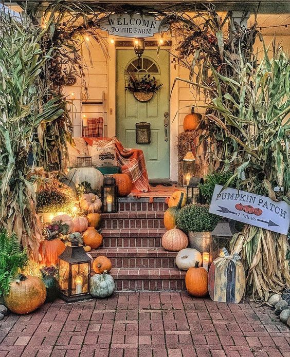 Tour this 200 year old farmhouse with fall front porch brimming with pumpkins kellyelko.com #farmhouse #frontporch #fallporch #pumpkins farmhousefall #farmhousedecor