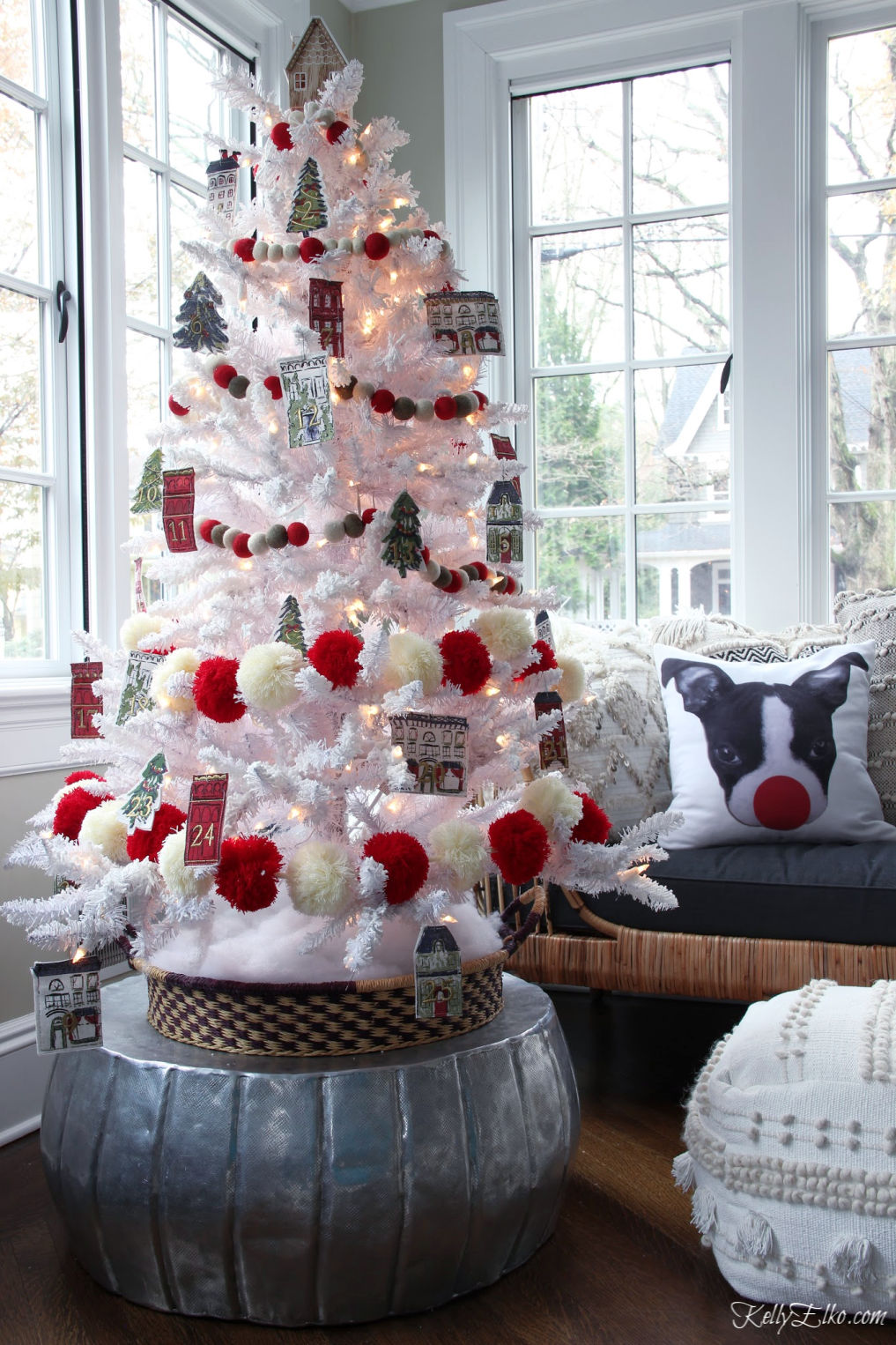 How cute is this Advent calendar Christmas tree to countdown to Christmas kellyelko.com #christmas #christmasdecor #christmastree #diychristmasdecor #adventcalendar #whitechristmastree #flockedchristmastree #redchristmas #pompoms #christmasgarland 