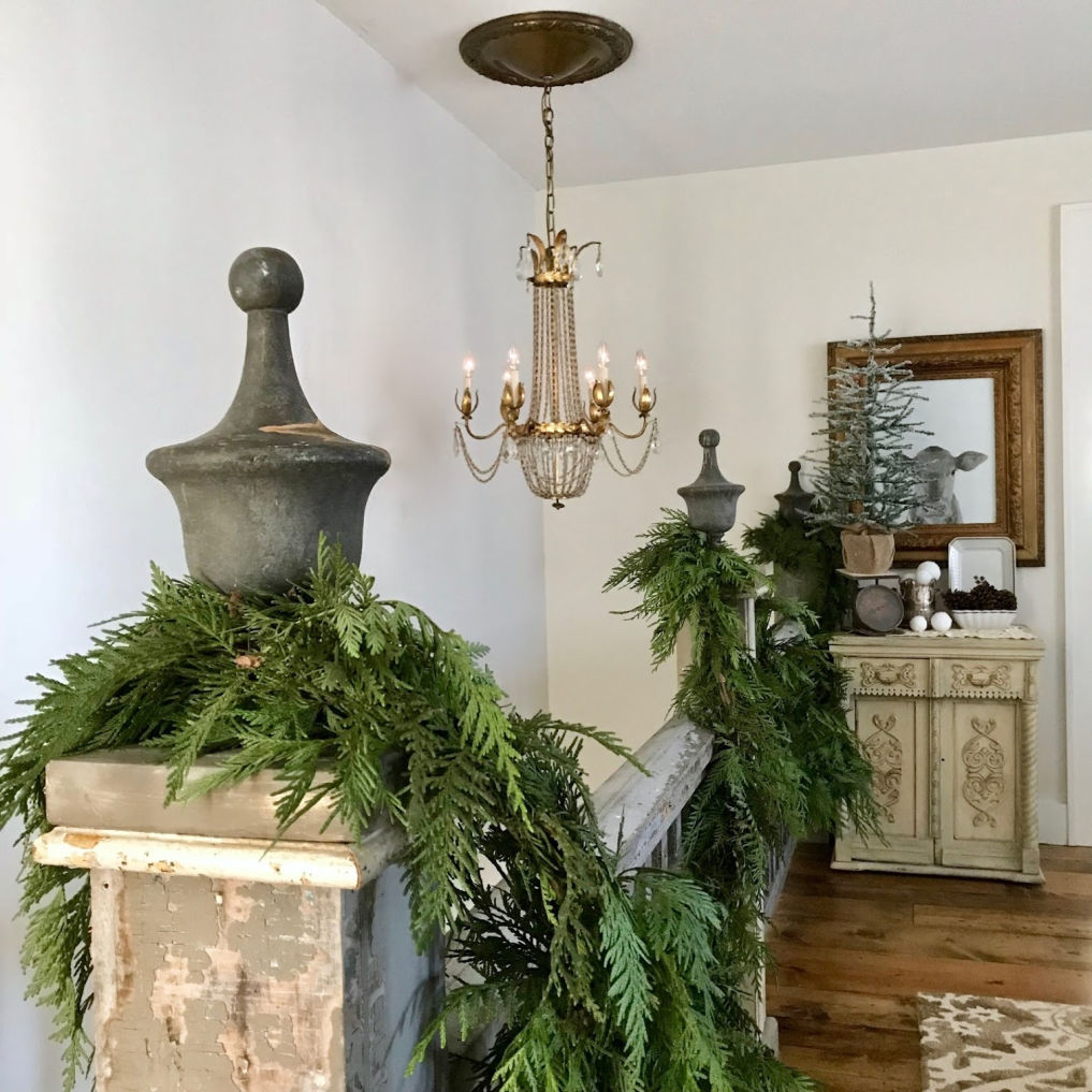 Fresh cedar garland on an antique bannister #christmas #christmasbannister #christmasgarland #vintagechristmas #farmhousechristmas 