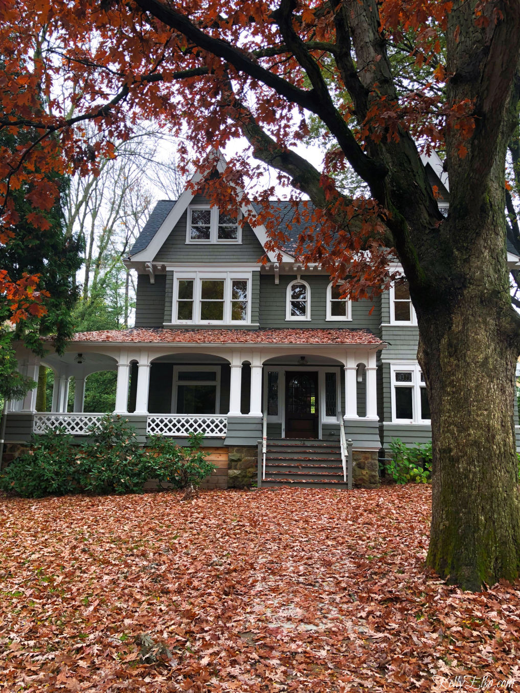 Kelly's Stamp of Approval - love this beautiful old house covered in colorful fall leaves kellyelko.com #fall #fallhome #fallfoliage #oldhouse #oldhome #fallporch #kellyelko 