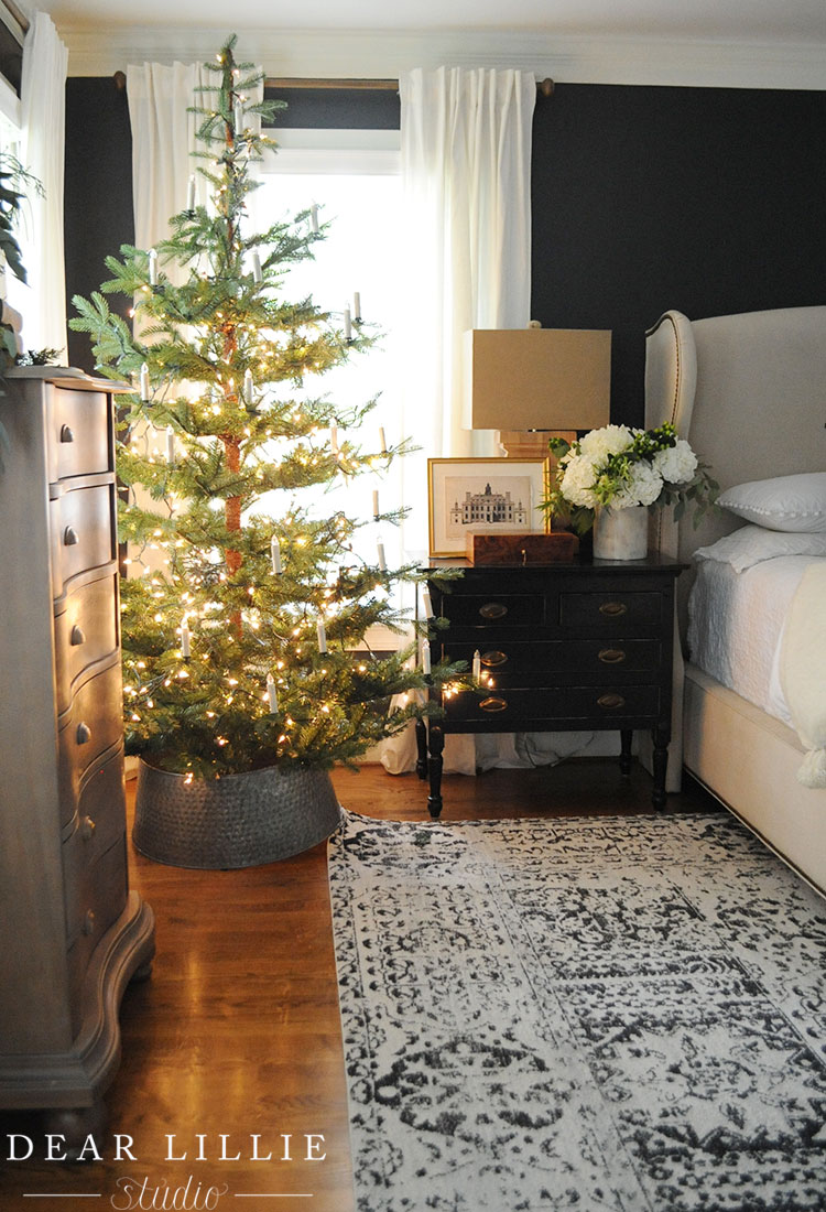 15 Sparse Christmas Trees - love this beautiful tree minimally decorated in lights and candles kellyelko.com #christmas #christmastree #sparsechristmastree #vintagechristmas #christmasdecor #christmasedecorating #christmasdecoratingideas #farmhousechristmas #christmasornaments #neutralchristmas #silvertip #kellyelko