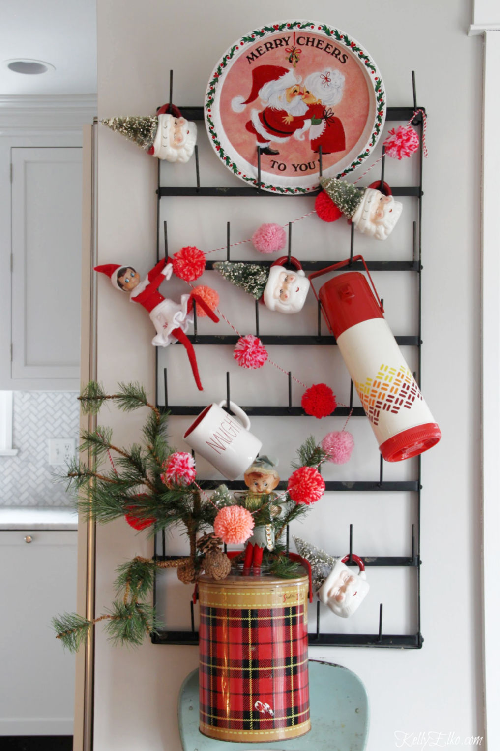 Vintage Christmas display - love the Santa mugs and old thermoses kellyelko.com #vintage #vintagedecor #vintagechristmas #santa #christmasdecor #christmaskitchen #kellyelko