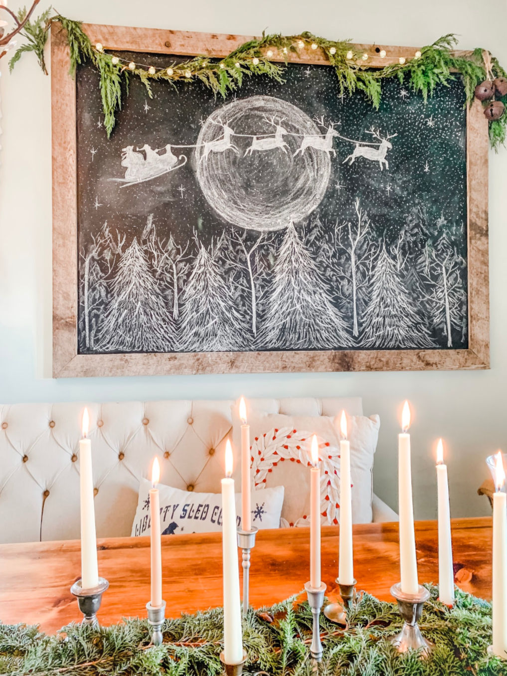 Stunning Christmas chalkboard with Santa and his reindeer flying across the moon. Inspired by the original art at kellyelko.com #chalkart #chalkboard #christmaschalkboard #christmaschalkart #santa #farmhousedecor #farmhousechristmas #christmasdecor #farmhousestyle #fixerupperstyle #kellyelko