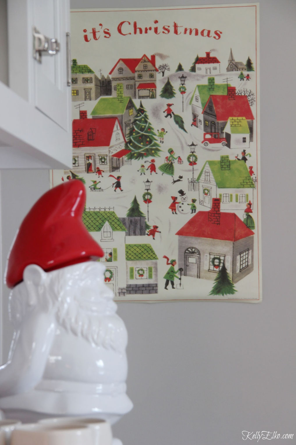 Colorful Christmas Home Tour - love the winter village art in the kitchen kellyelko.com #christmas #christmasdecor #christmasdecorating #christmashome #christmastour #diychristmas #christmasideas #christmasmantel #christmastree #christmasornaments #vintagechristmas #farmhousechristmas #colorfulchristmas #creativechristmas #kellyelko #gnome #christmasvillage #christmasart 